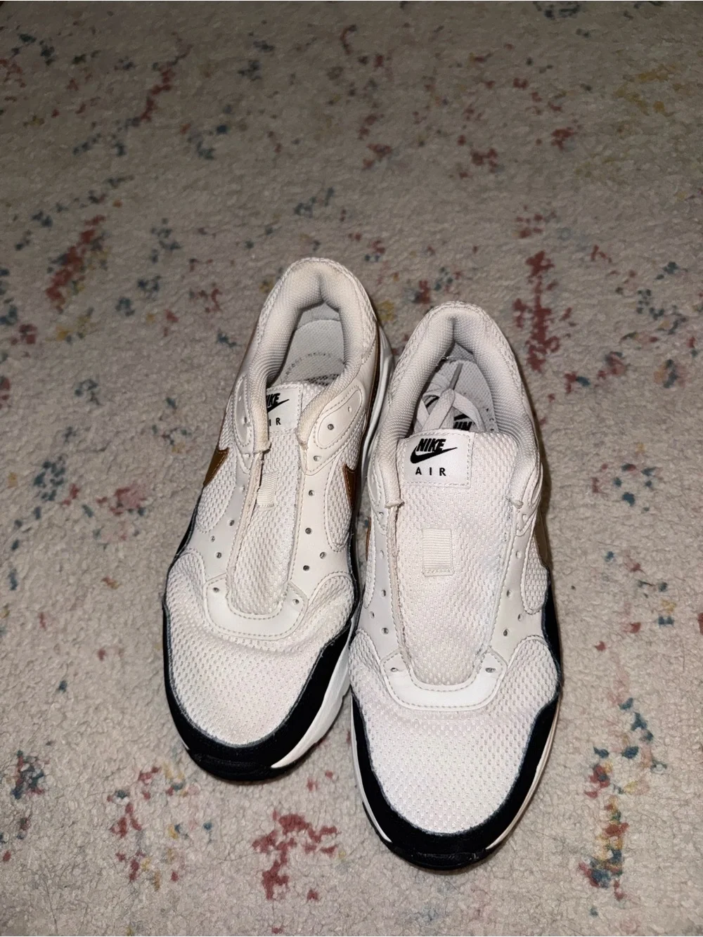 Nike White Sneakers with Black Trim and Gold Swoosh